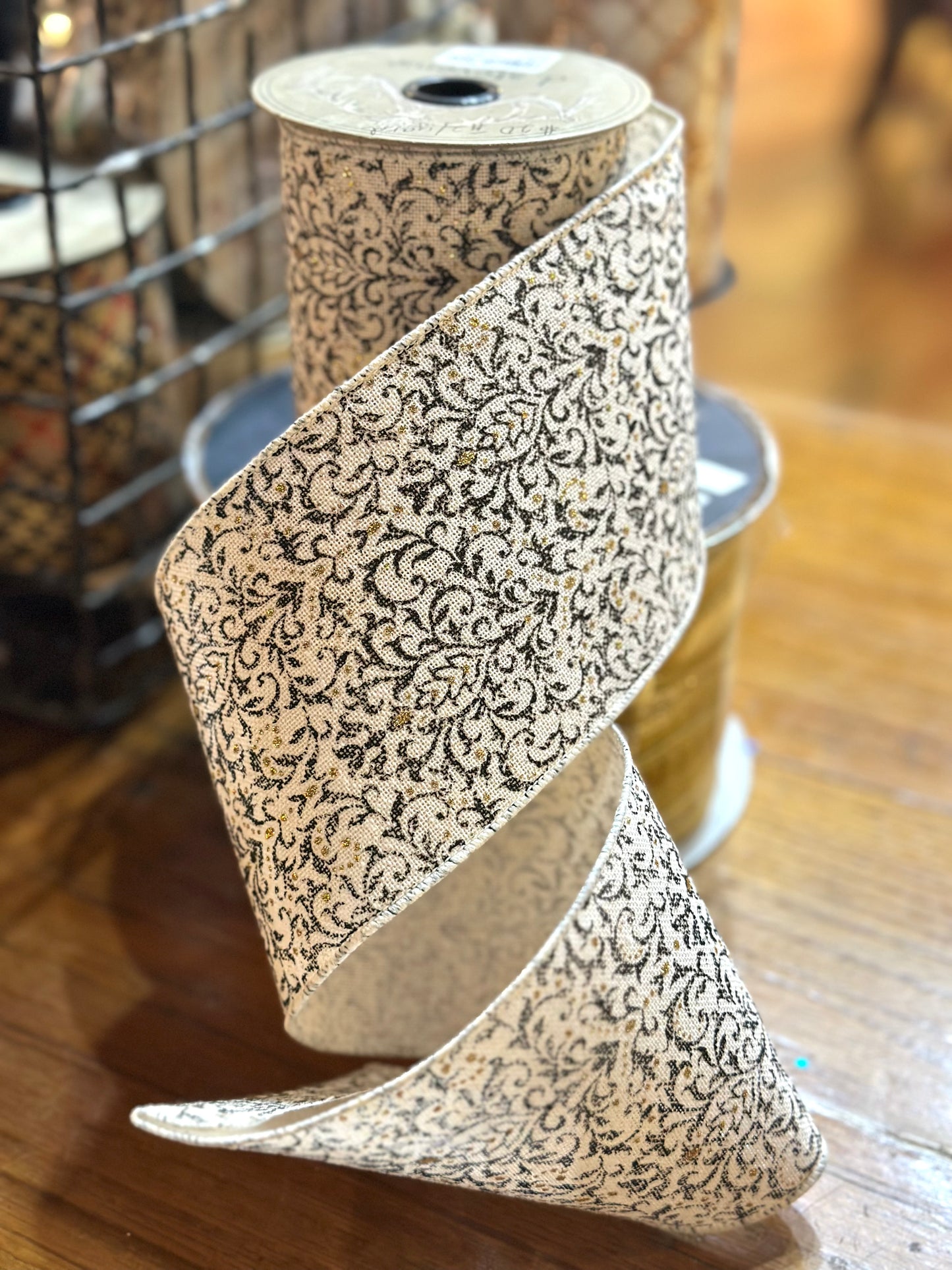 4”x10yards linen cream ribbon with black detailing and gold glitter accents