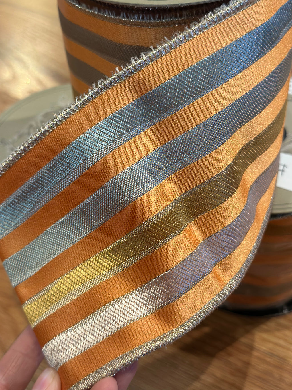 4” x 10yrds Orange ribbon with silver and gold stripes