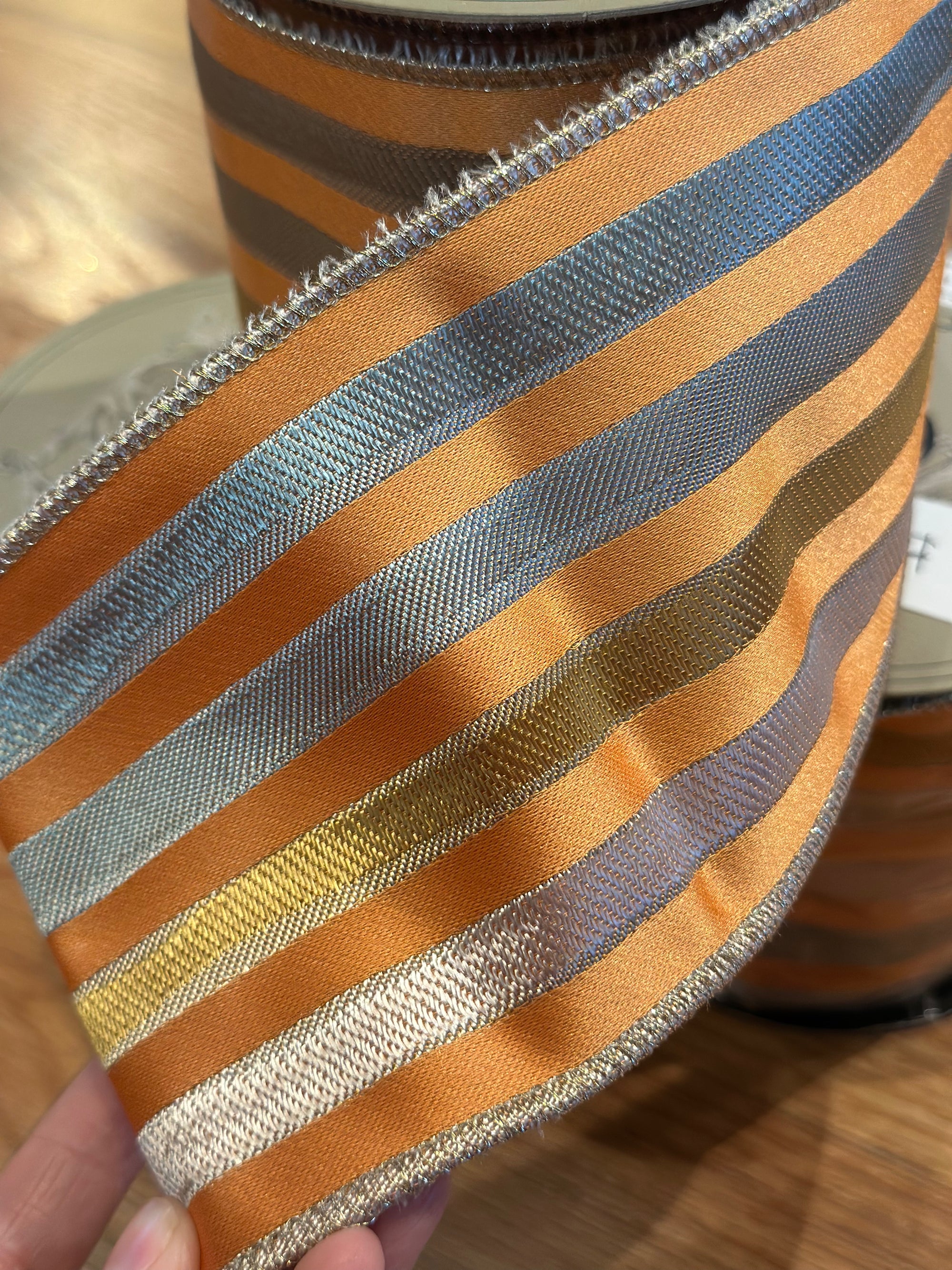 4” x 10yrds Orange ribbon with silver and gold stripes